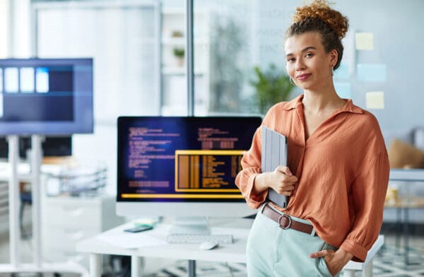 Female young programmer working at office